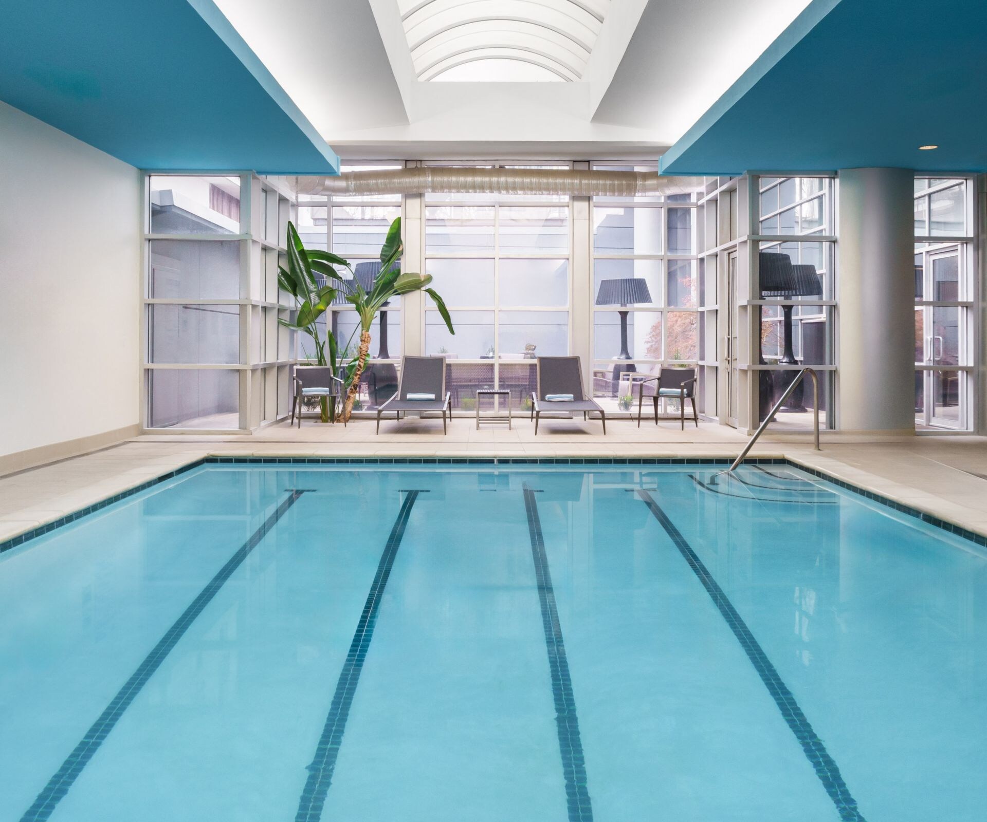 Indoor pool area with pool chairs