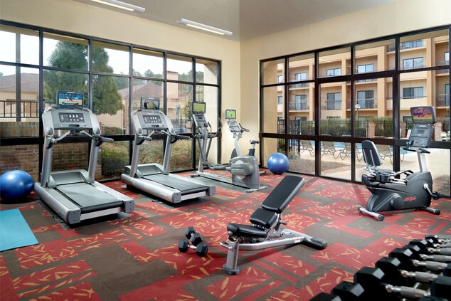 hotel gym with treadmills, elliptical and weights