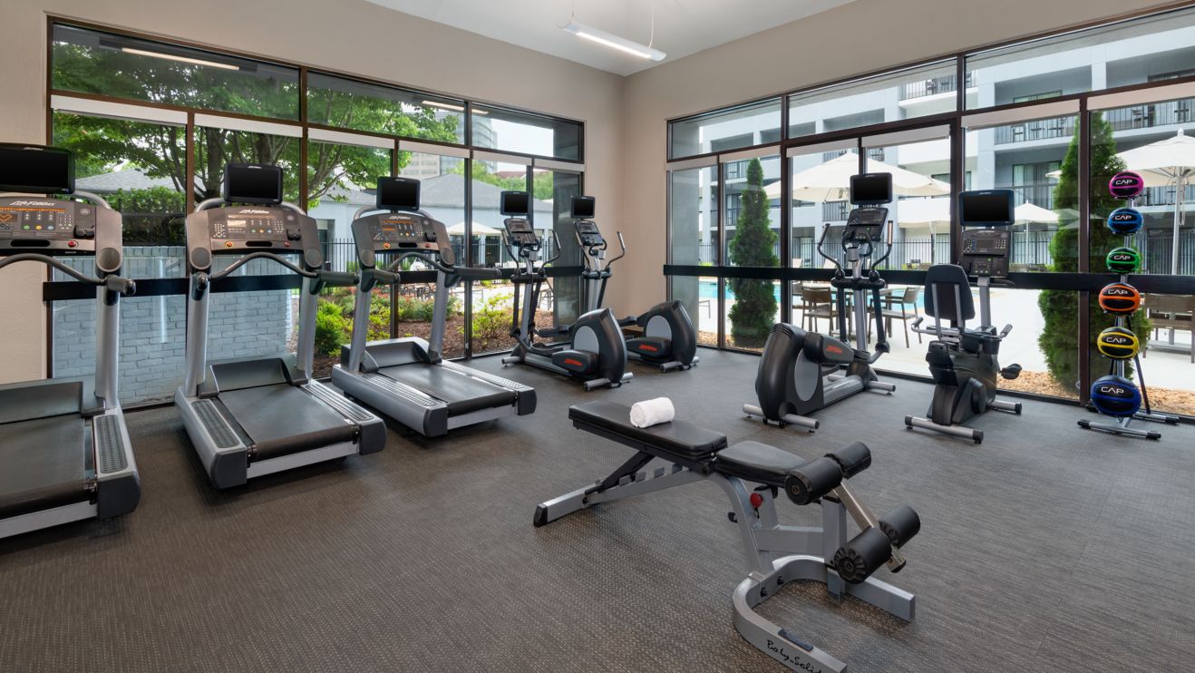 fitness center with treadmills and bikes