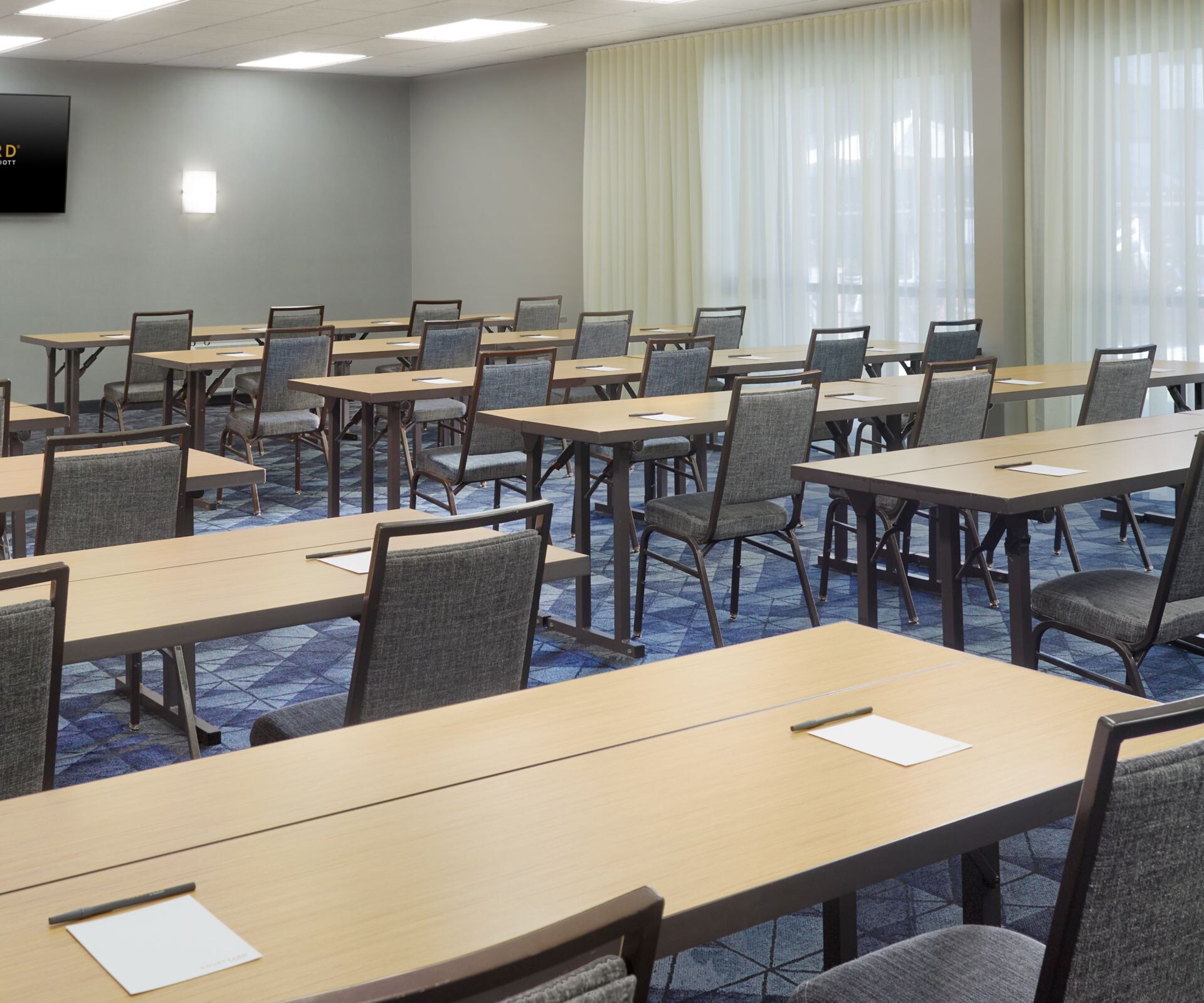 rows of table with chairs set up like classroom