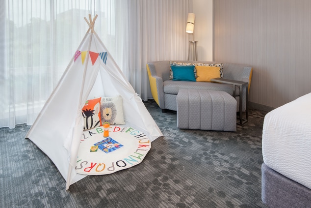 Child's play tent in exec suite next to sofa