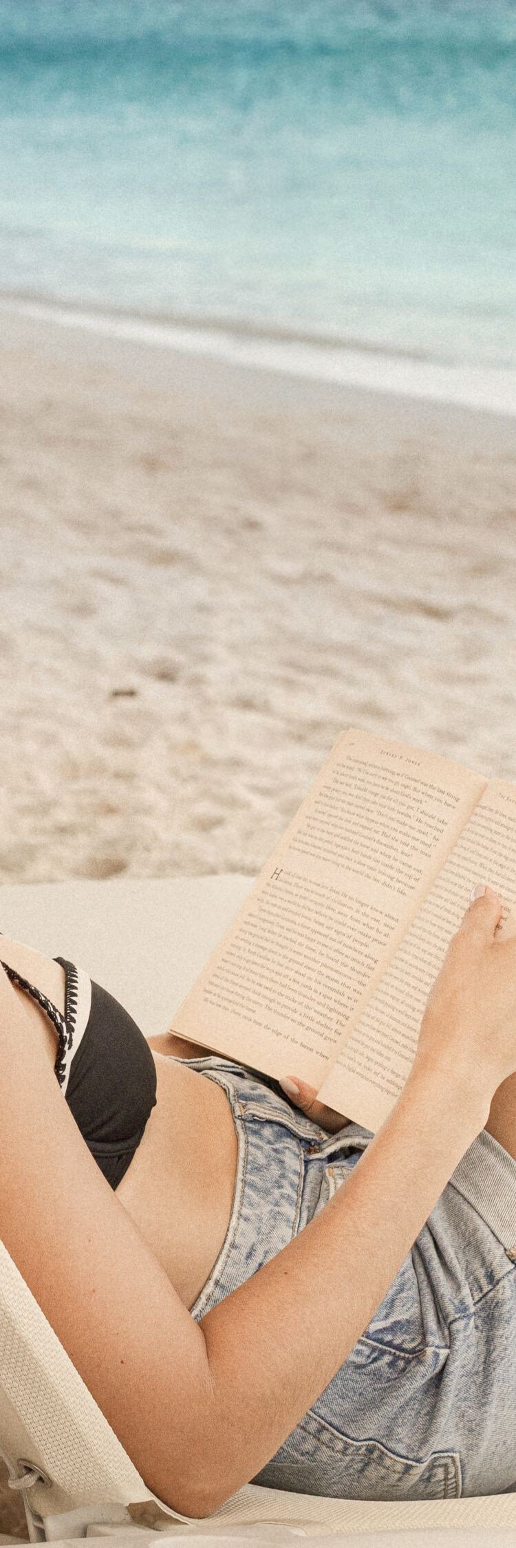 Guest reading on beach lounger