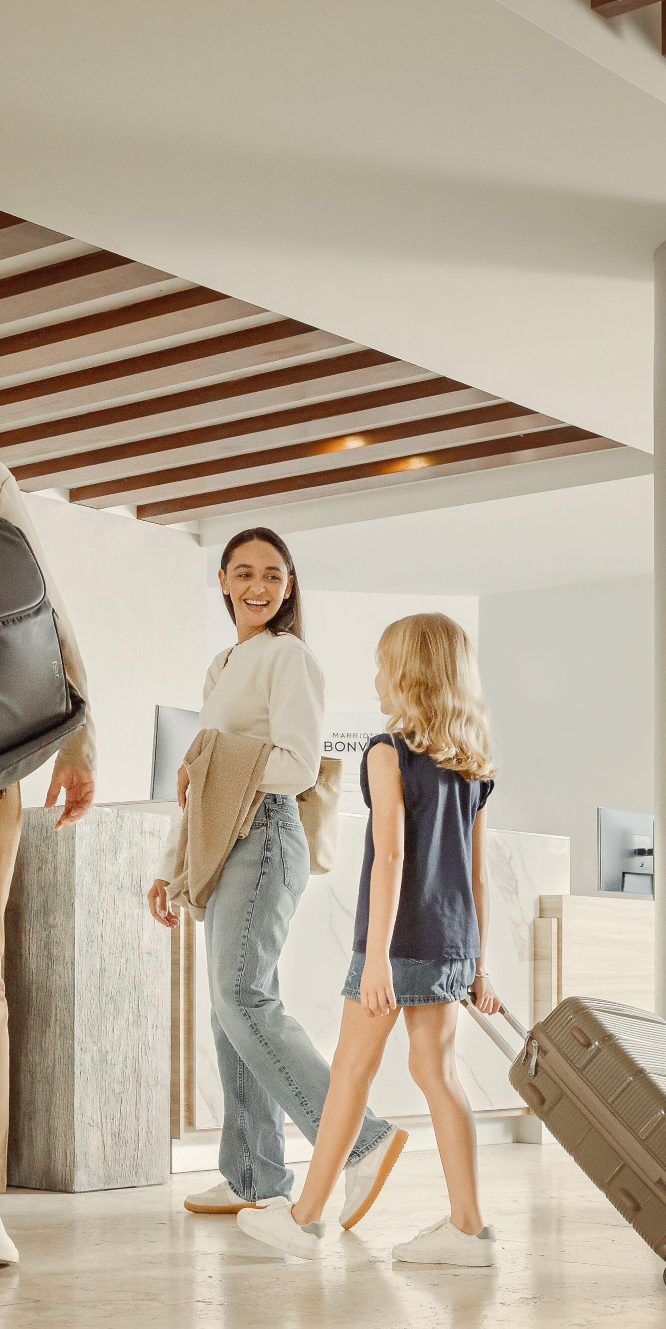 Family checking in at marble front desk