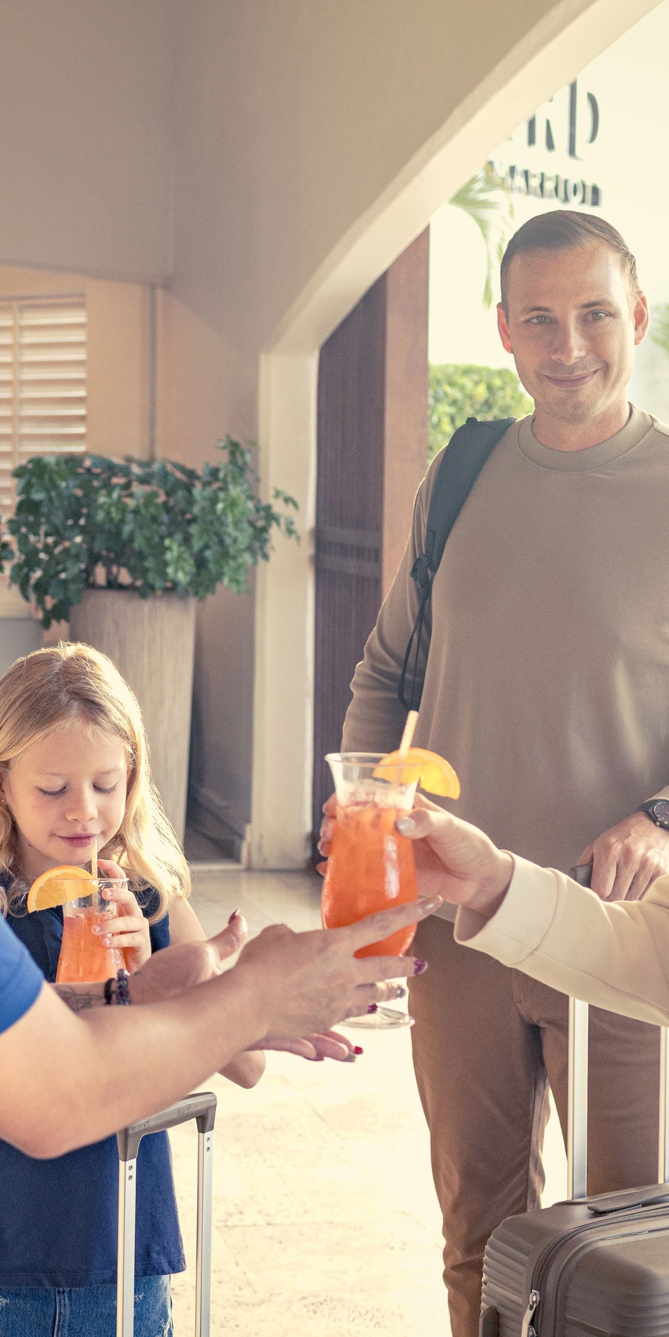 Staff greeting family with welcome drinks