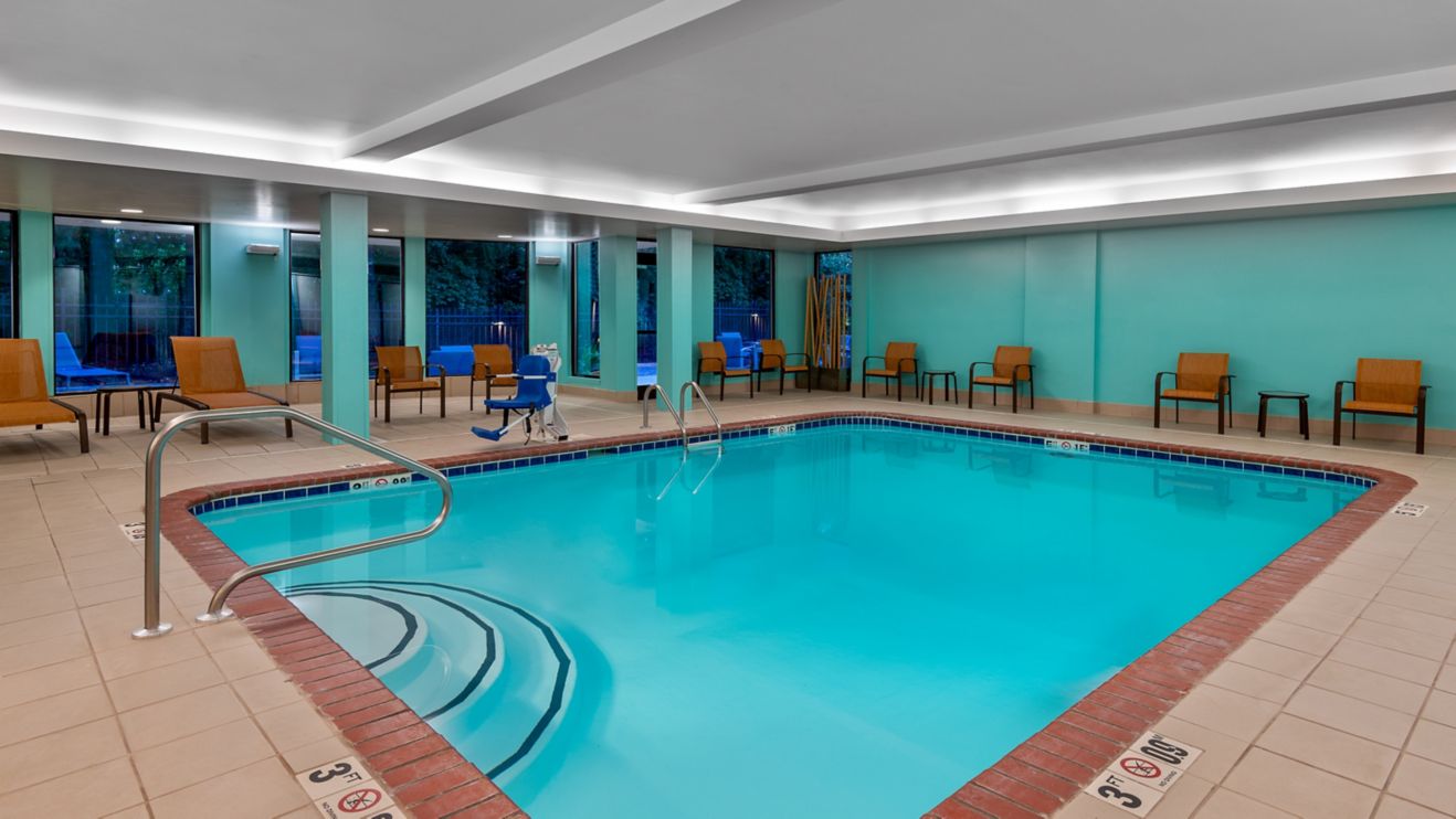 Indoor Pool Area with lounge chairs