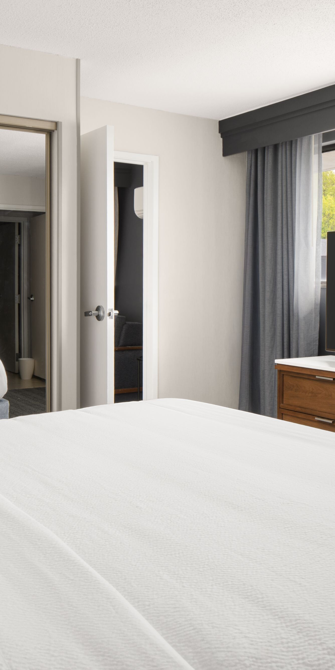 King guest room with mirror and TV