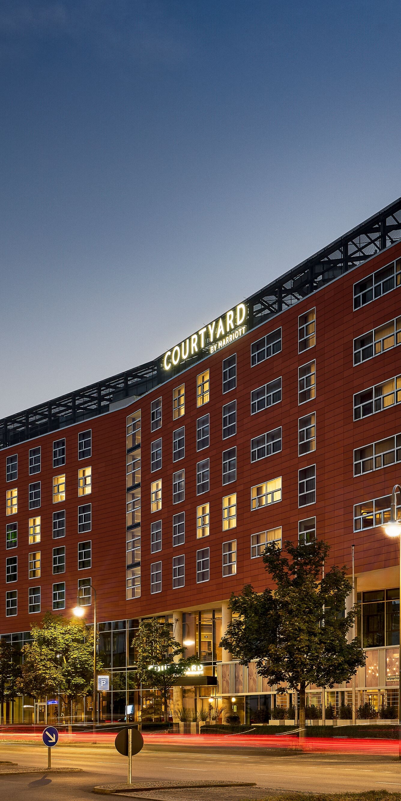 Exterior hotel at night lit up by street