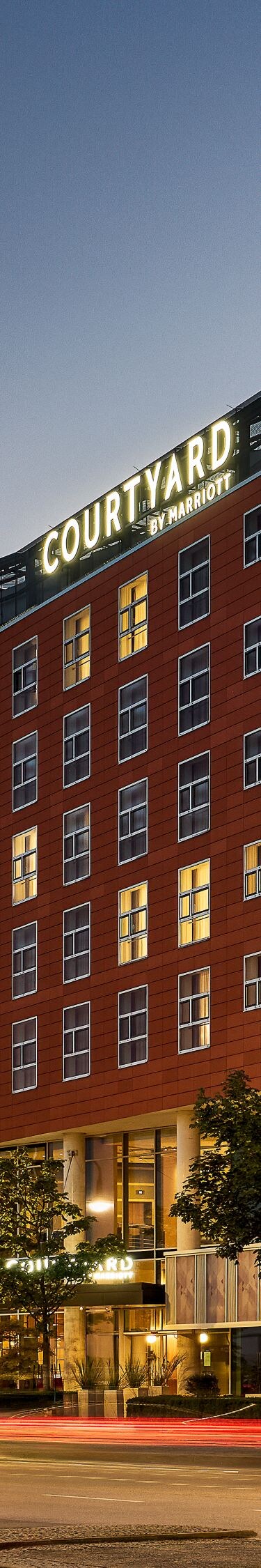 Exterior hotel at night lit up by street