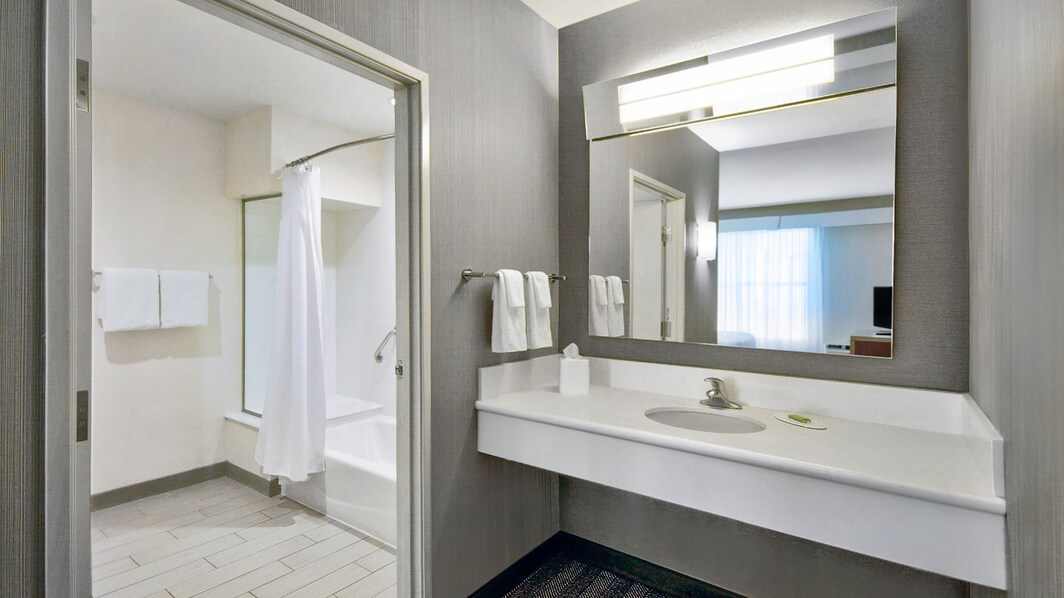 image of bathroom vanity and shower/tub combo