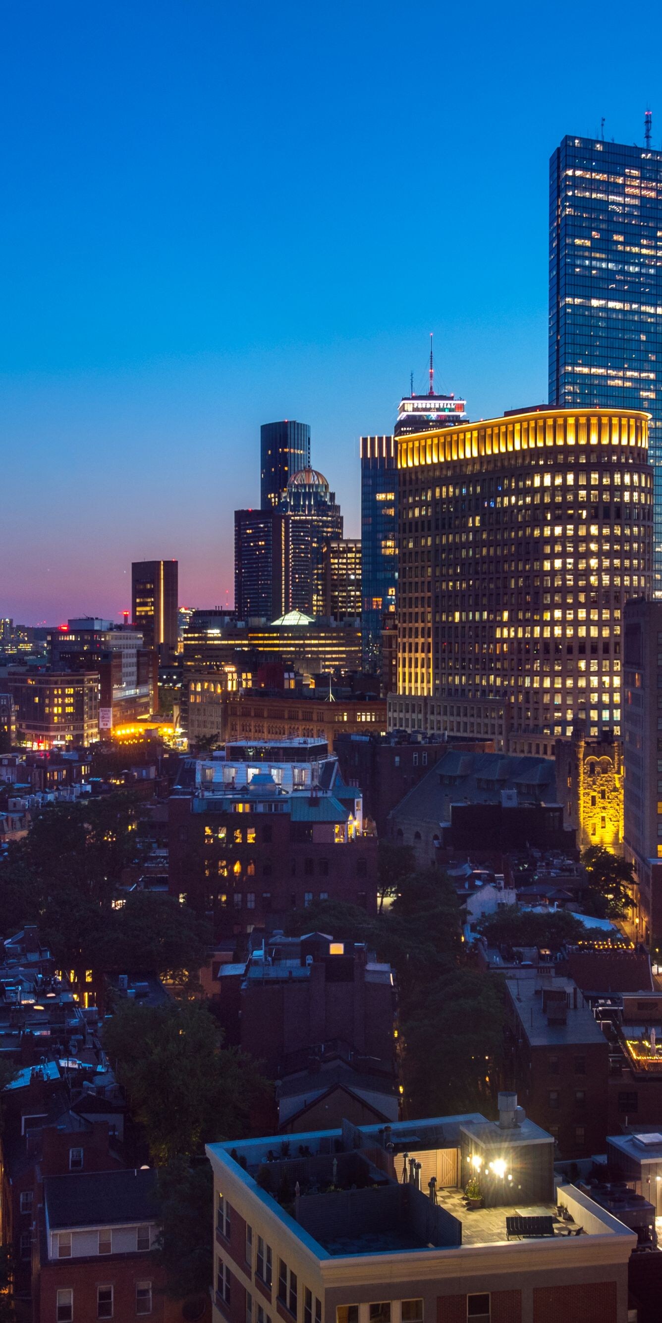 Boston skyline at dusk with city lights