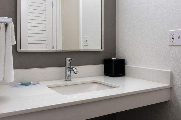 bathroom sink, mirror, towel, tissues