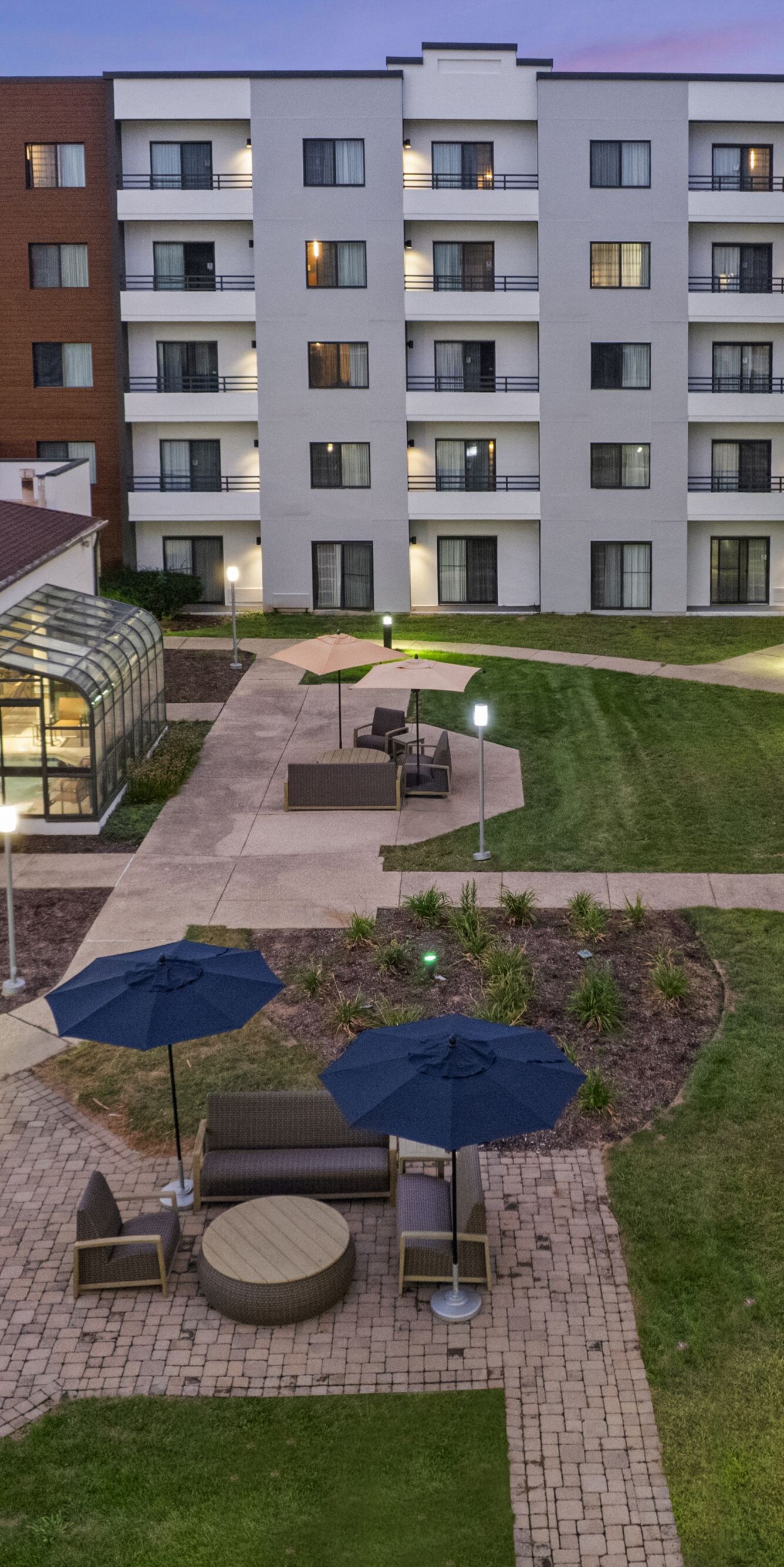 Illuminated courtyard with pathways and seating