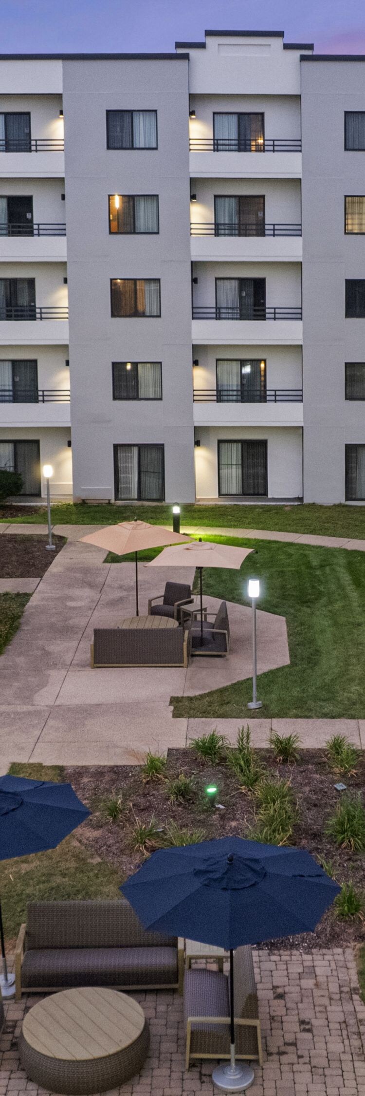 Illuminated courtyard with pathways and seating