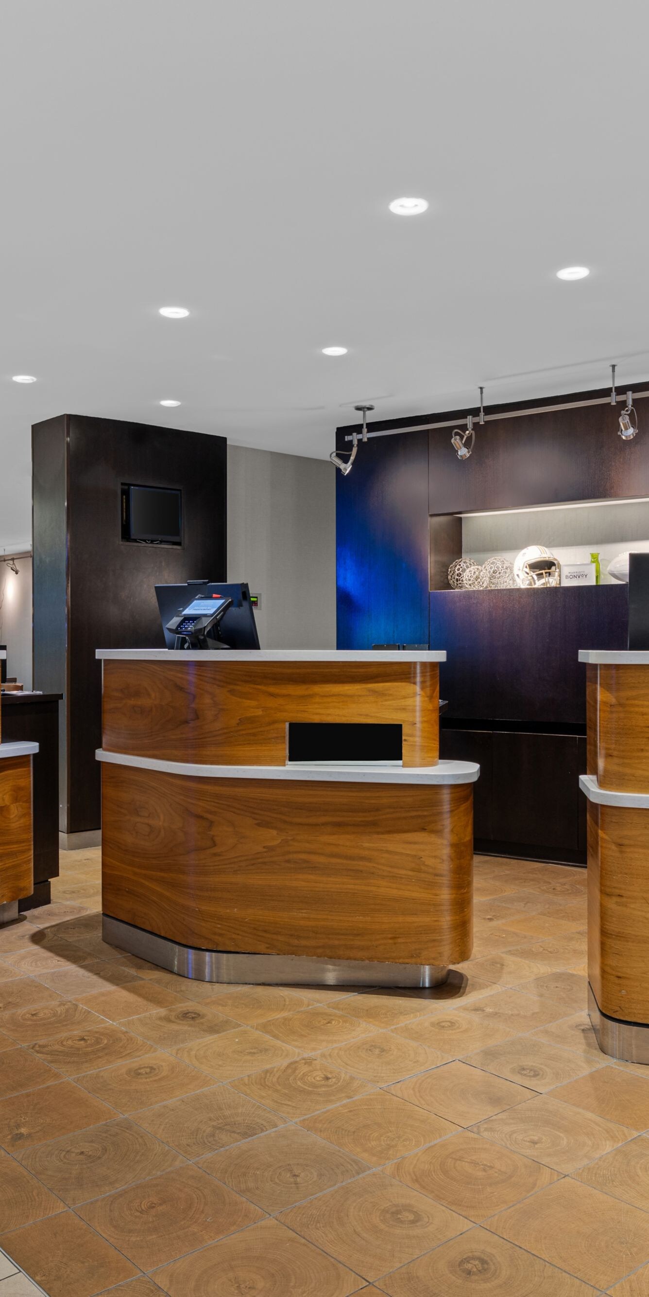 Curved wood front desks in hotel lobby