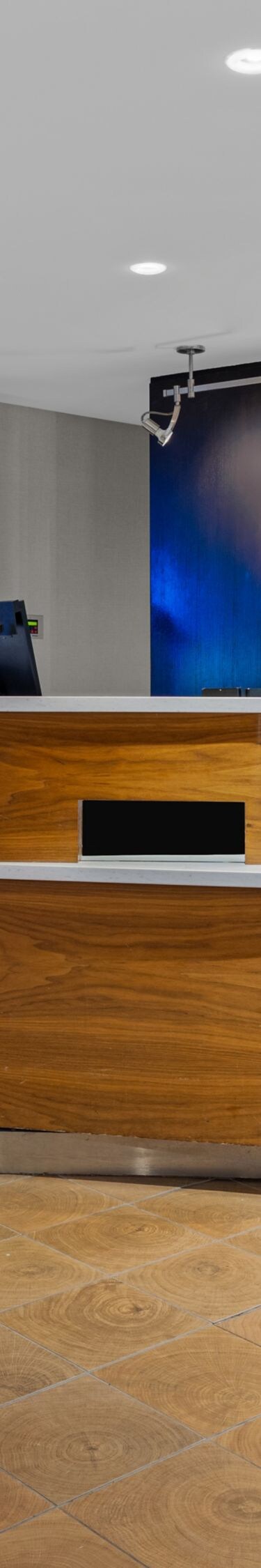 Curved wood front desks in hotel lobby
