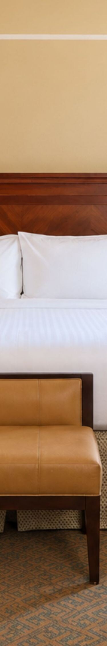 king bed, dresser, sitting area, and tv