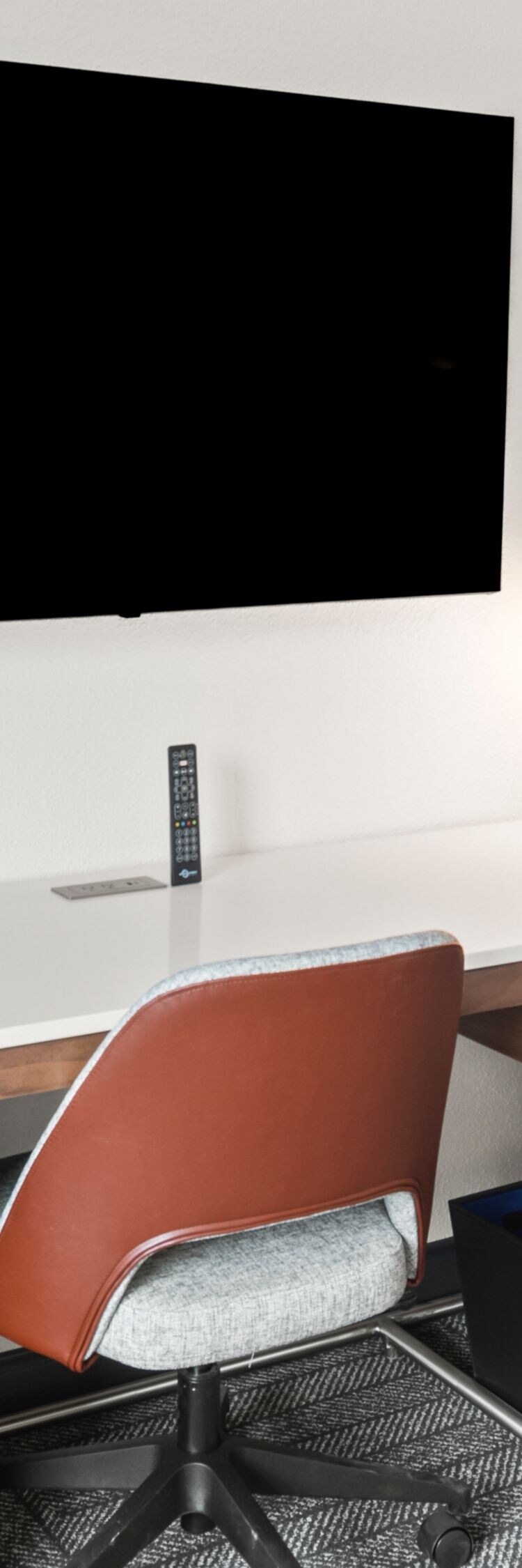 desk, chair, tv, and luggage rack