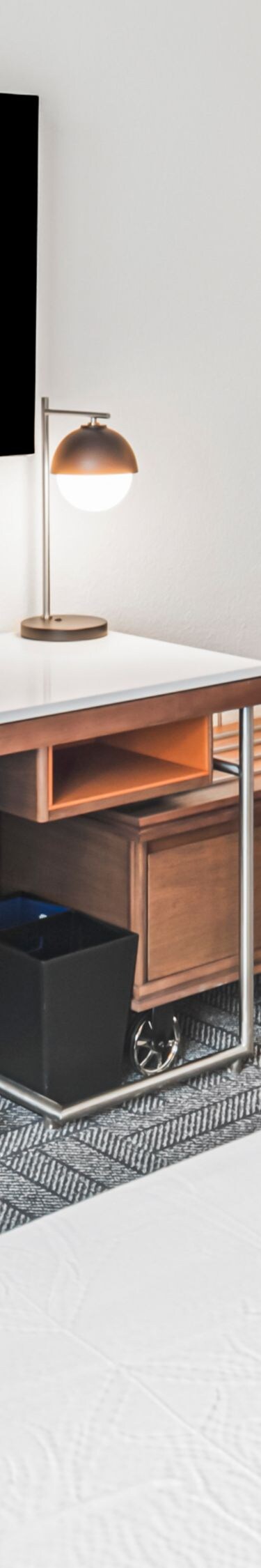 two beds, desk, chair, wall-mounted tv
