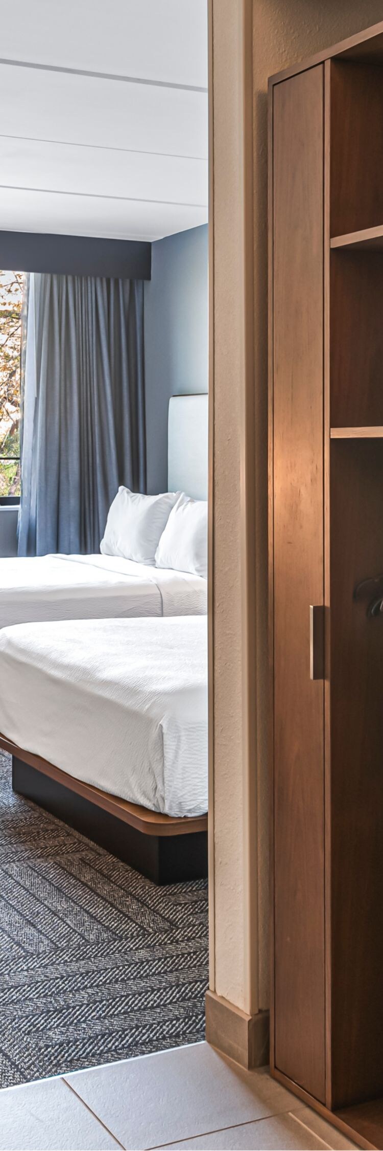 roll-in shower and view into a guest room