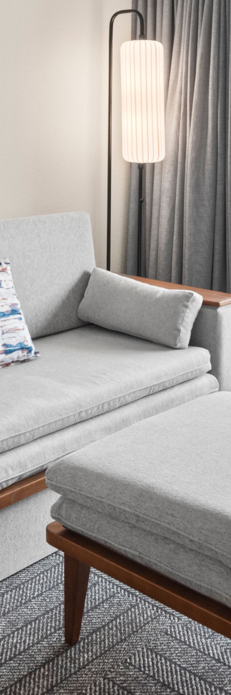 sofa, ottoman and balcony with pool view