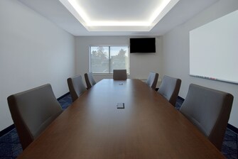 boardroom with conference table and tv