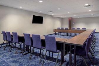conference room with table, chairs and tv