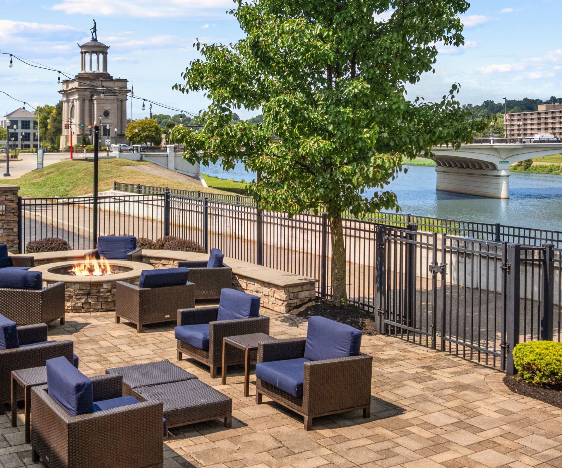Outdoor area with fireplace and chairs near river