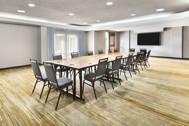 meeting room with conference table windows and tv