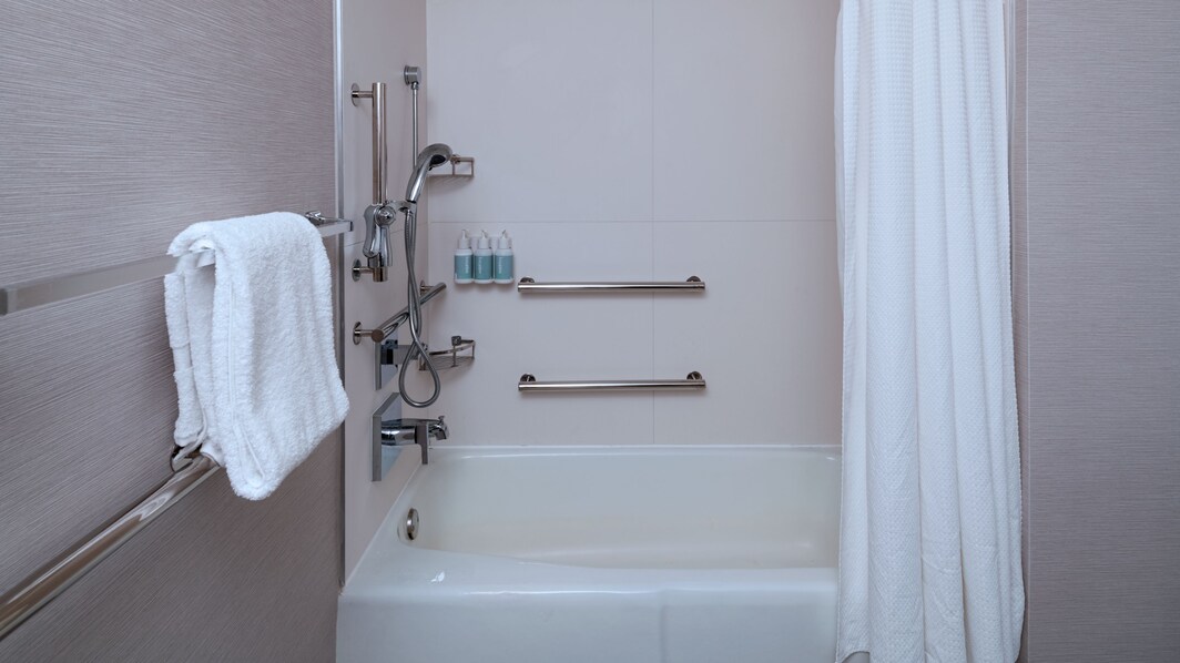 Accessible tub with support bar