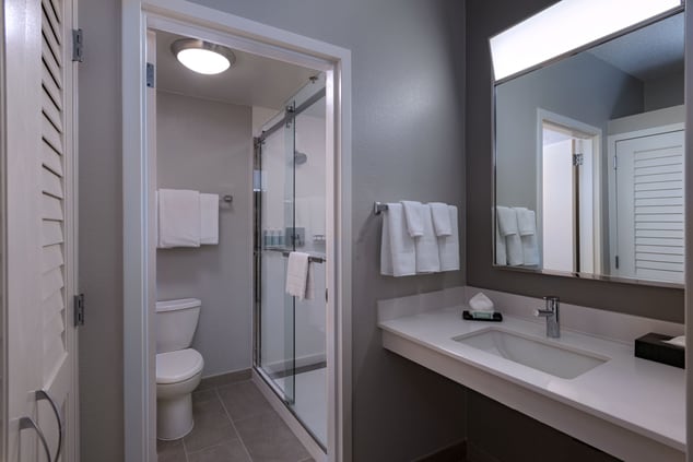 Bathroom featuring a shower stall and vanity