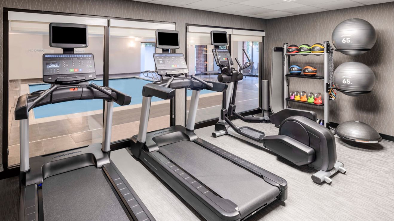 Cardio machines, free weights, view of pool