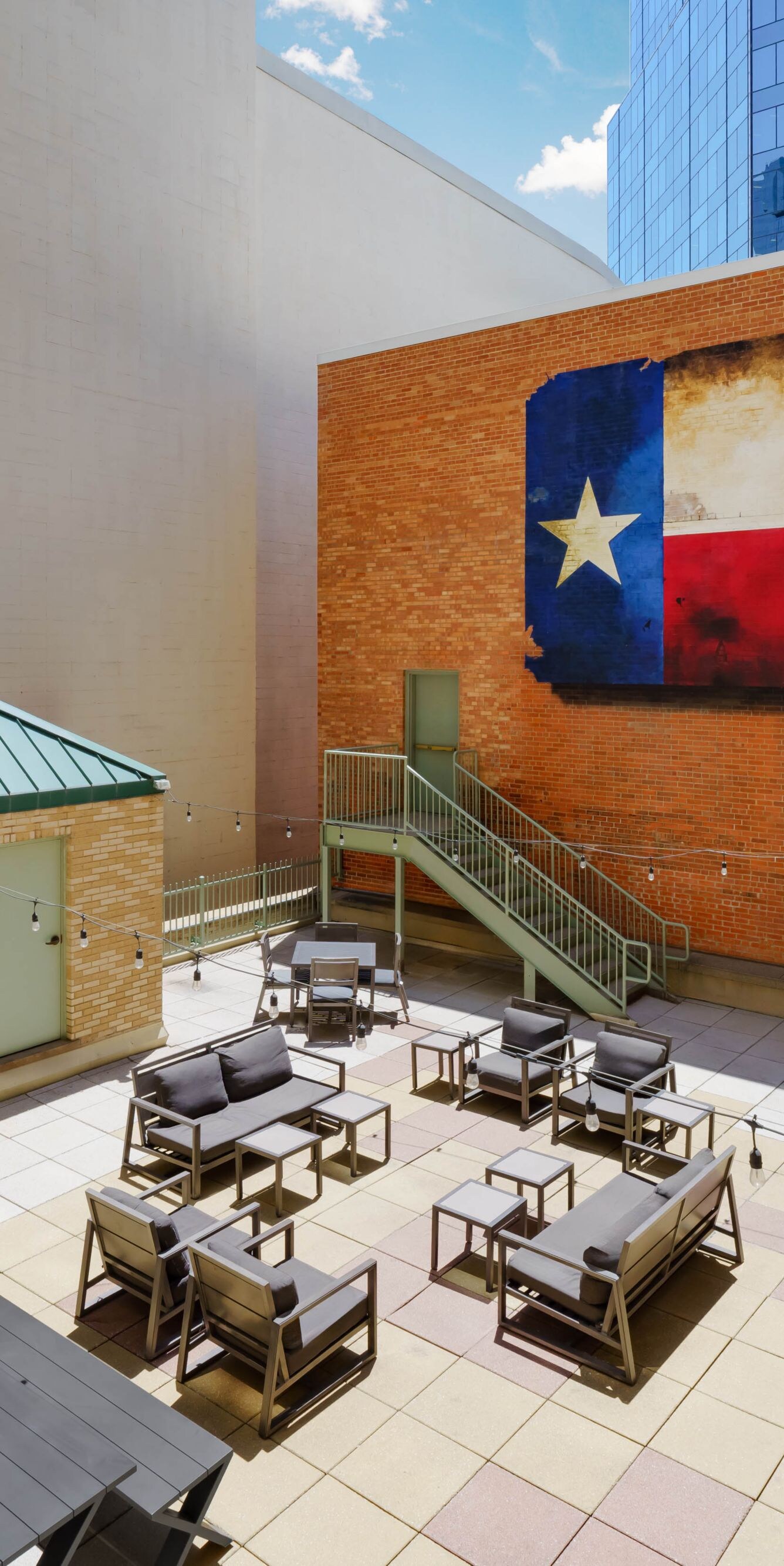 Rooftop patio featuring Texas flag mural.
