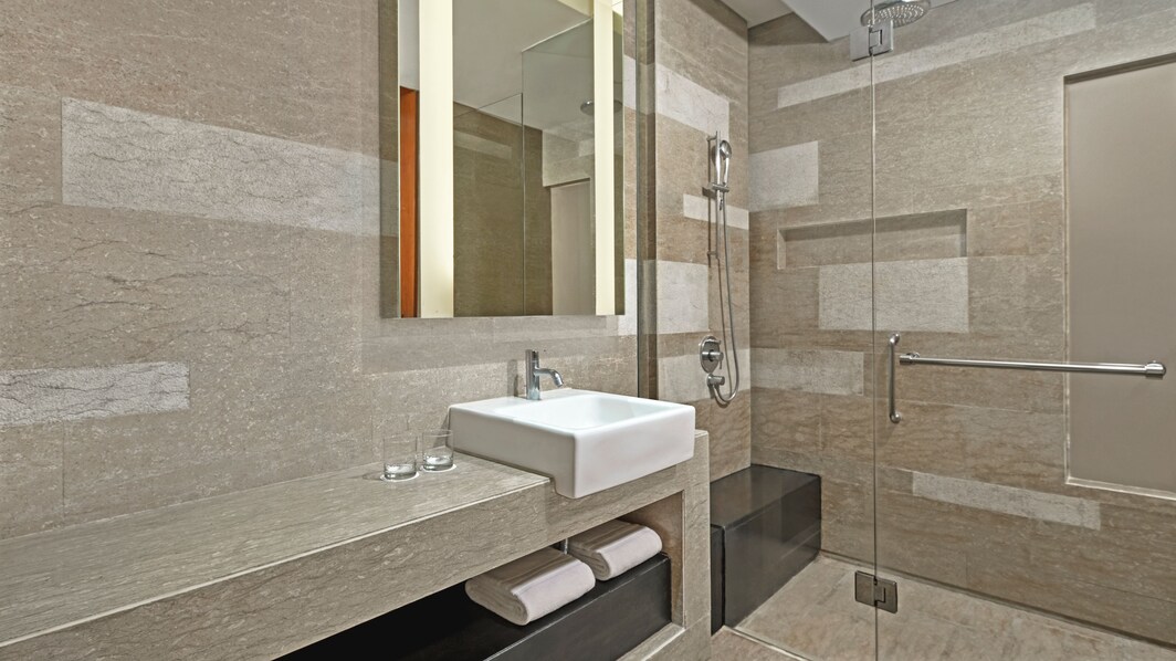 Bathroom sink and standing shower. 