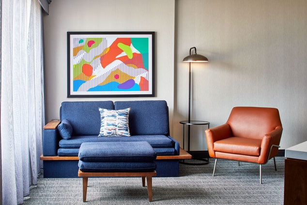 sofa, chair, artwork on wall, lamp, guest room
