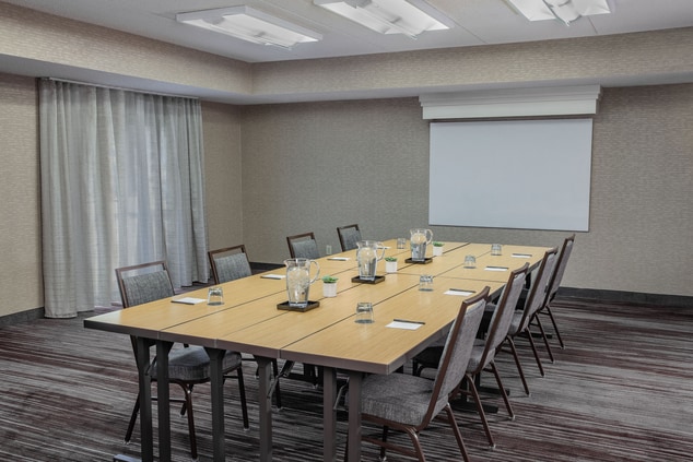 meeting room with conference setup, water & AV