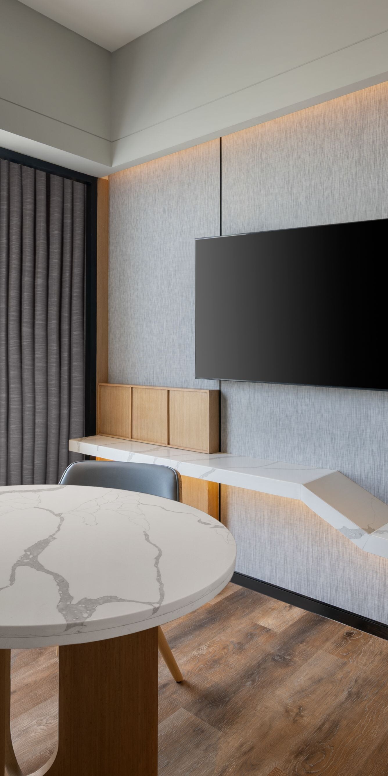 Suite living area with a table and city view.
