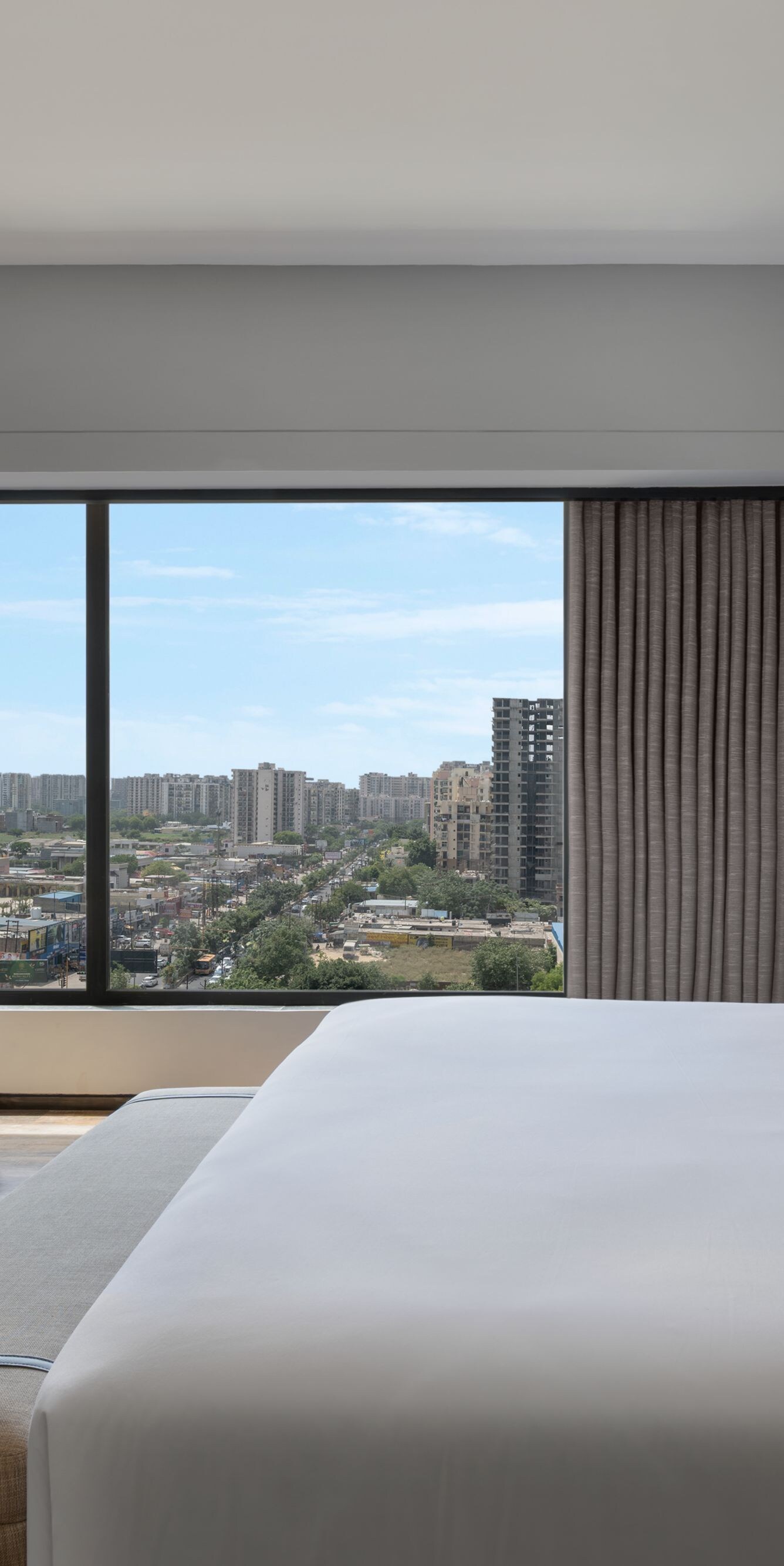 Suite bedroom with a king bed and city view.