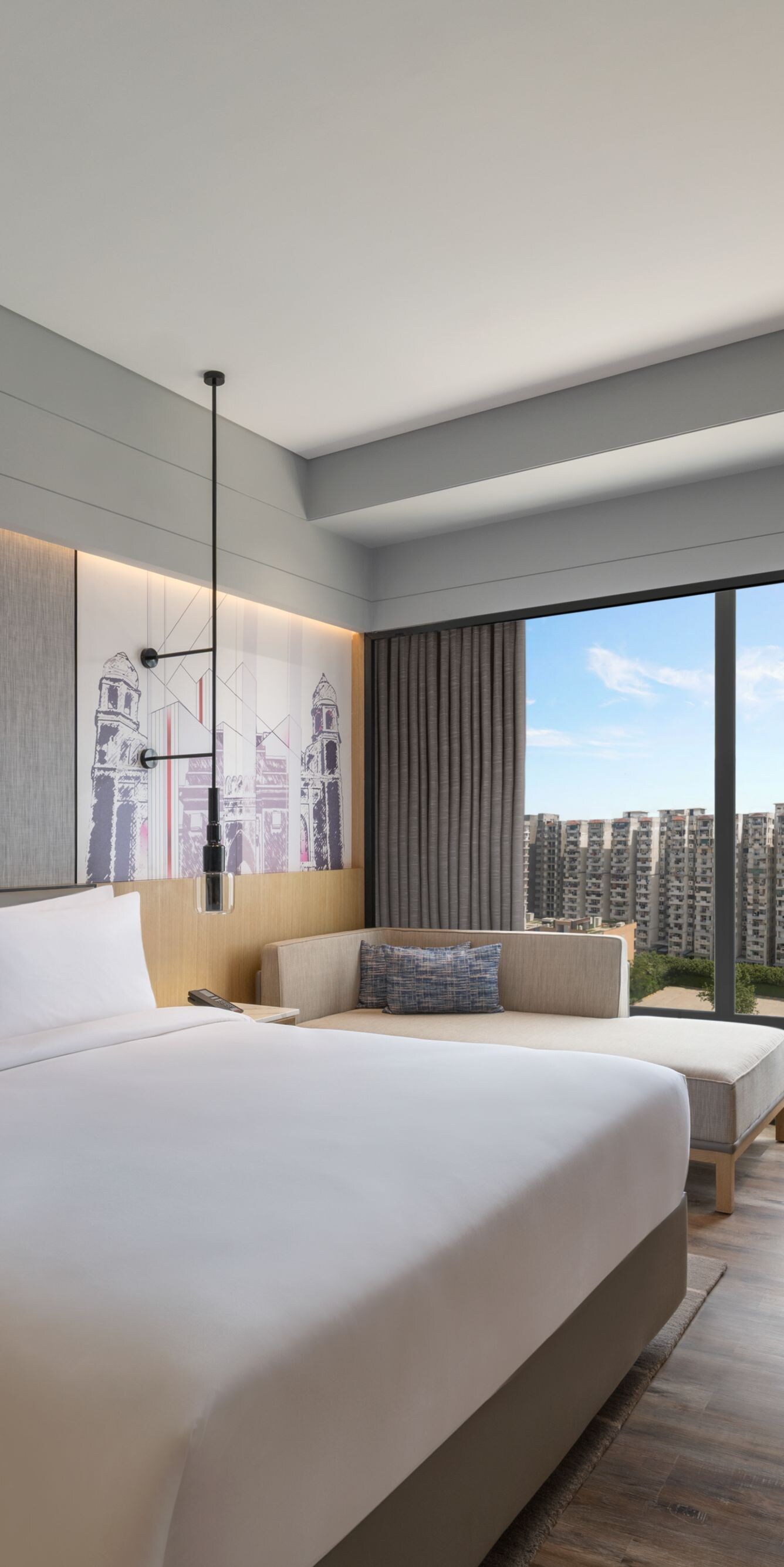 Guest room with a king bed and city view.