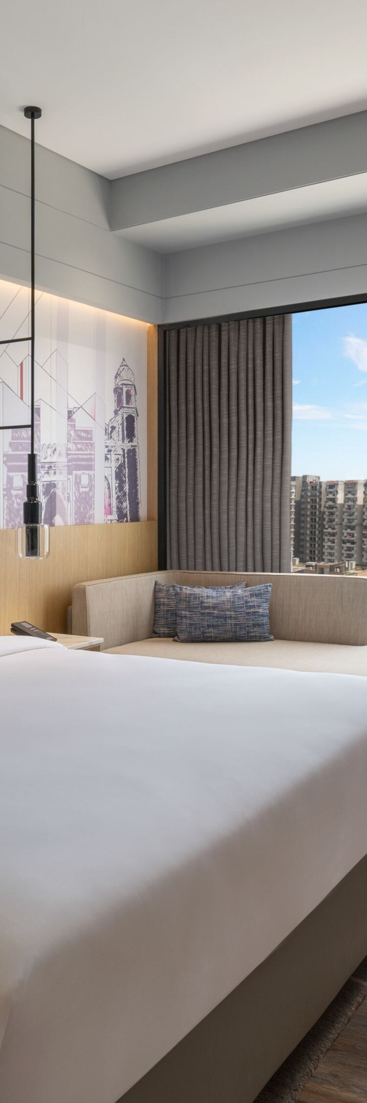 Guest room with a king bed and city view.