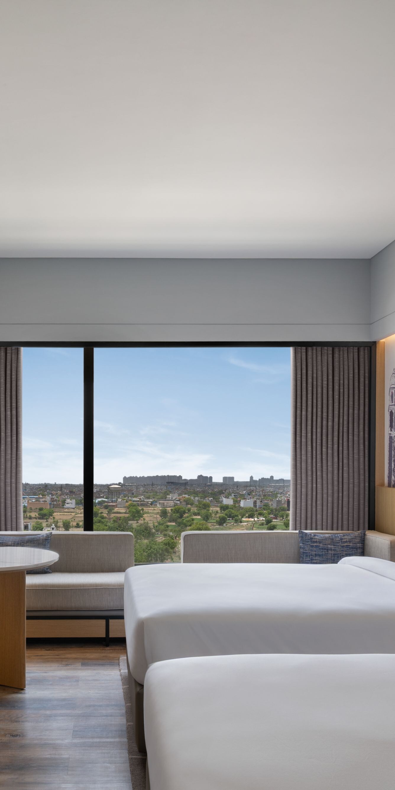 Guest room with two twin beds and city view.