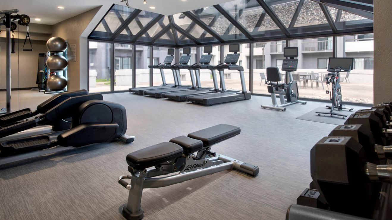 Spacious fitness center with courtyard view