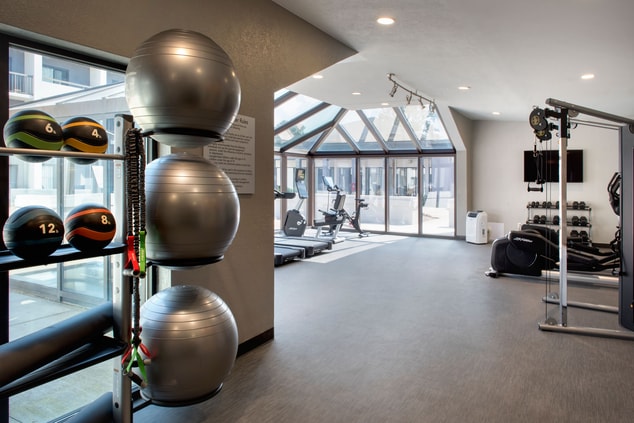 Spacious fitness center with TV and views