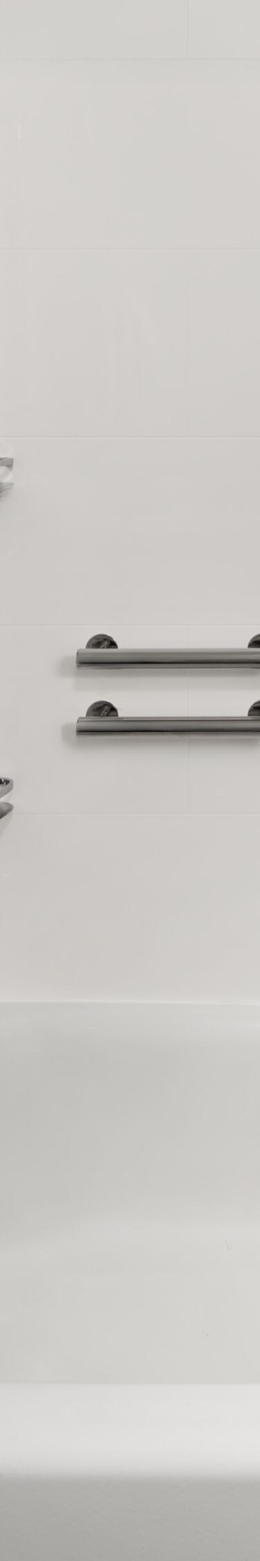 Shower‑tub with grab bars and a shower chair