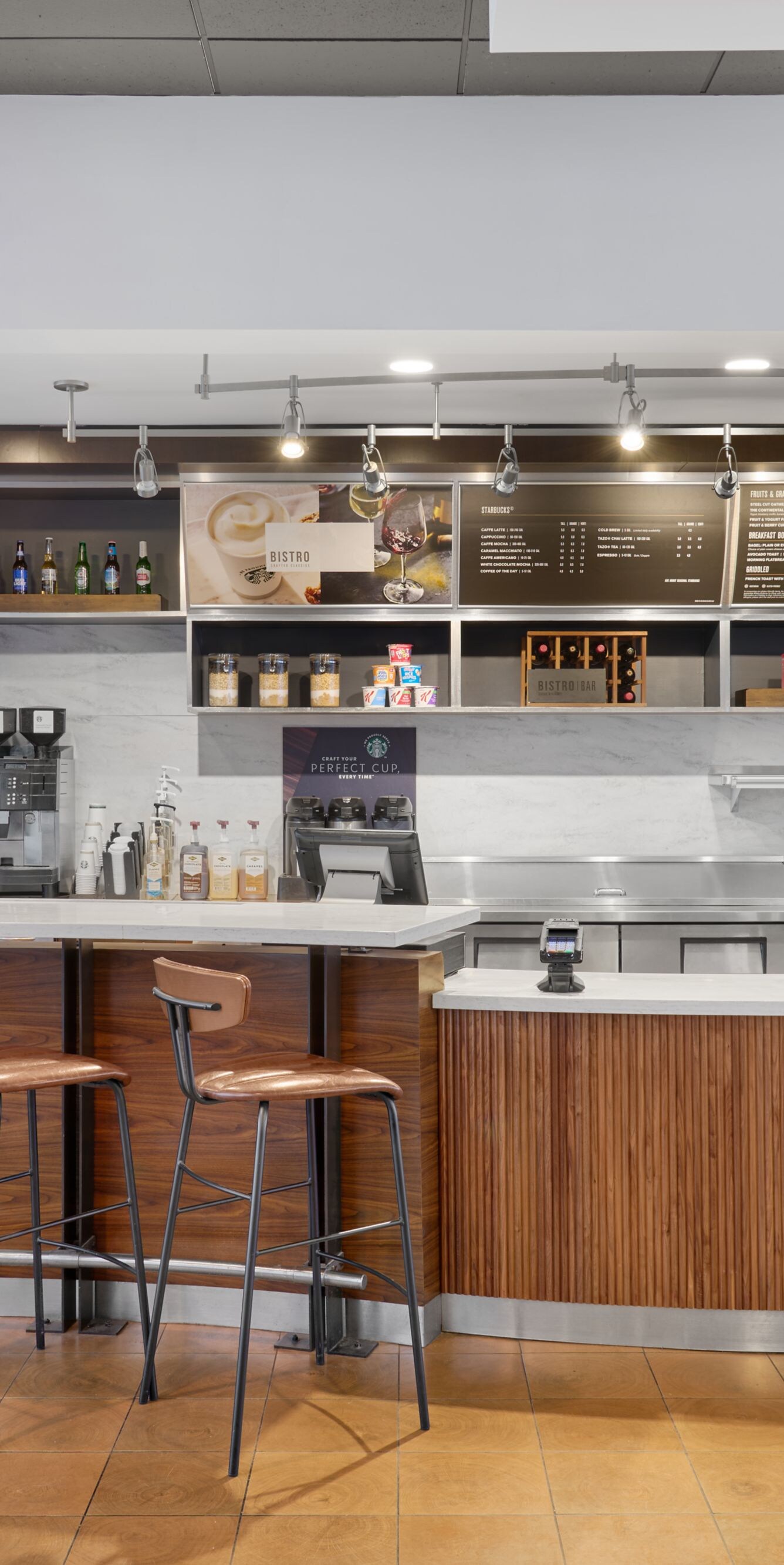 Café counter with stools and display of drinks