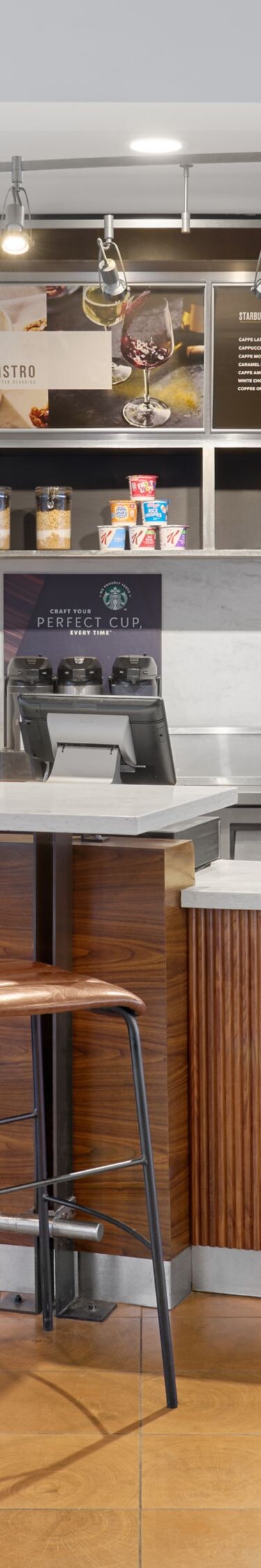 Café counter with stools and display of drinks