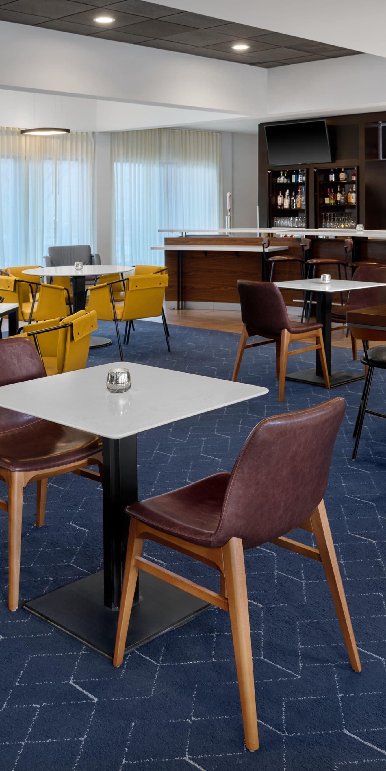 dining area with tables, chairs, and bar counter