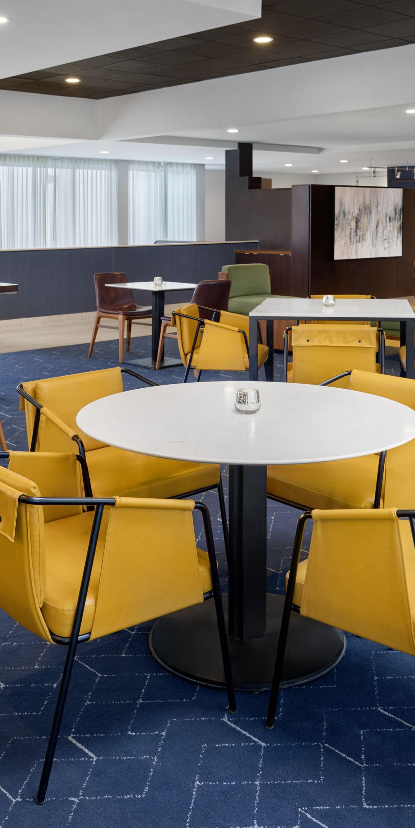 Bistro dining area with tables and yellow chairs