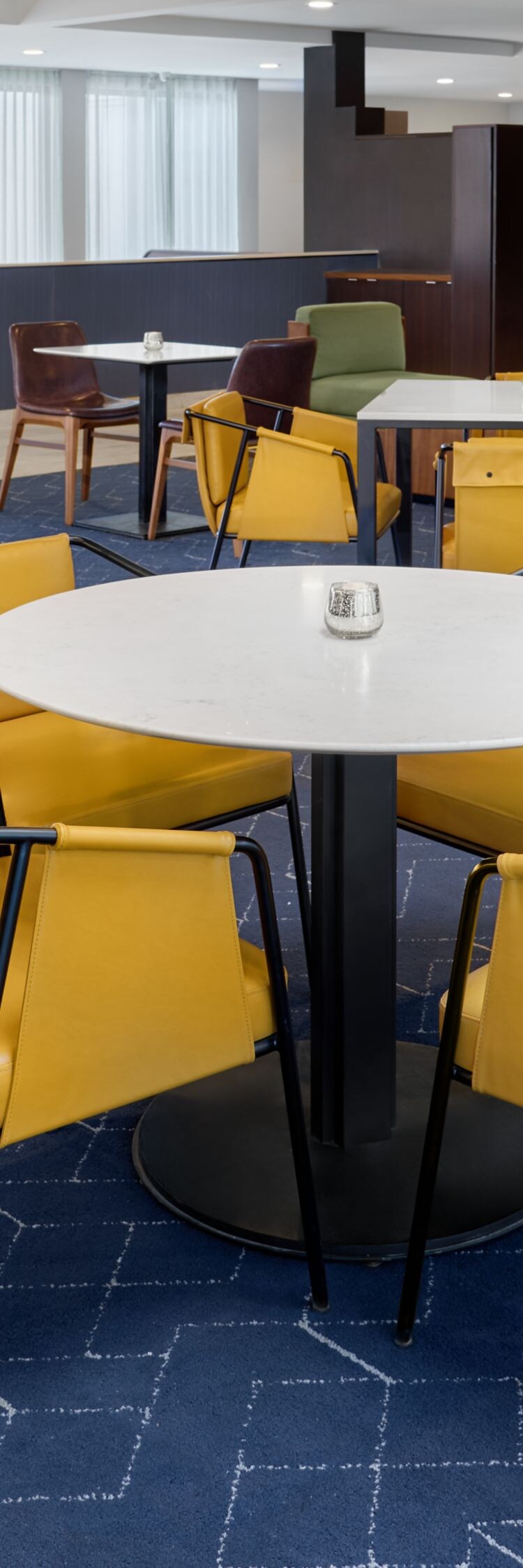 Bistro dining area with tables and yellow chairs