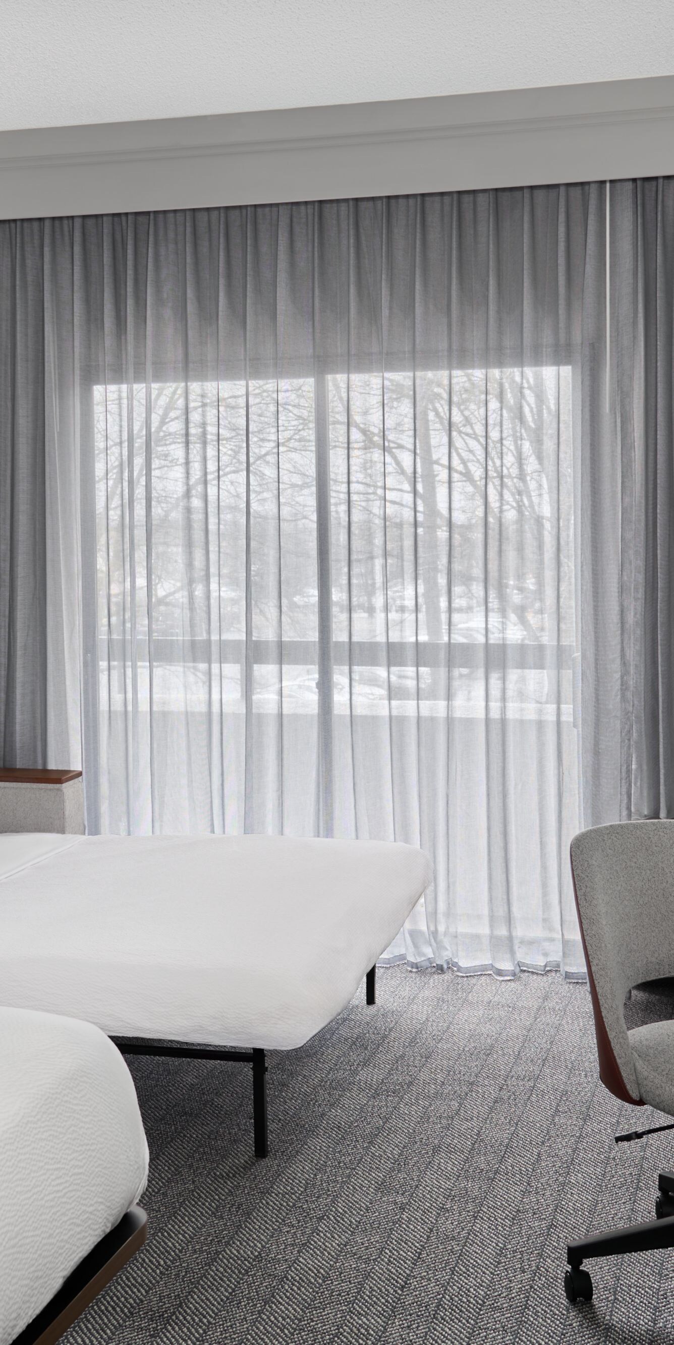 King bed with sofa bed, desk, and balcony view