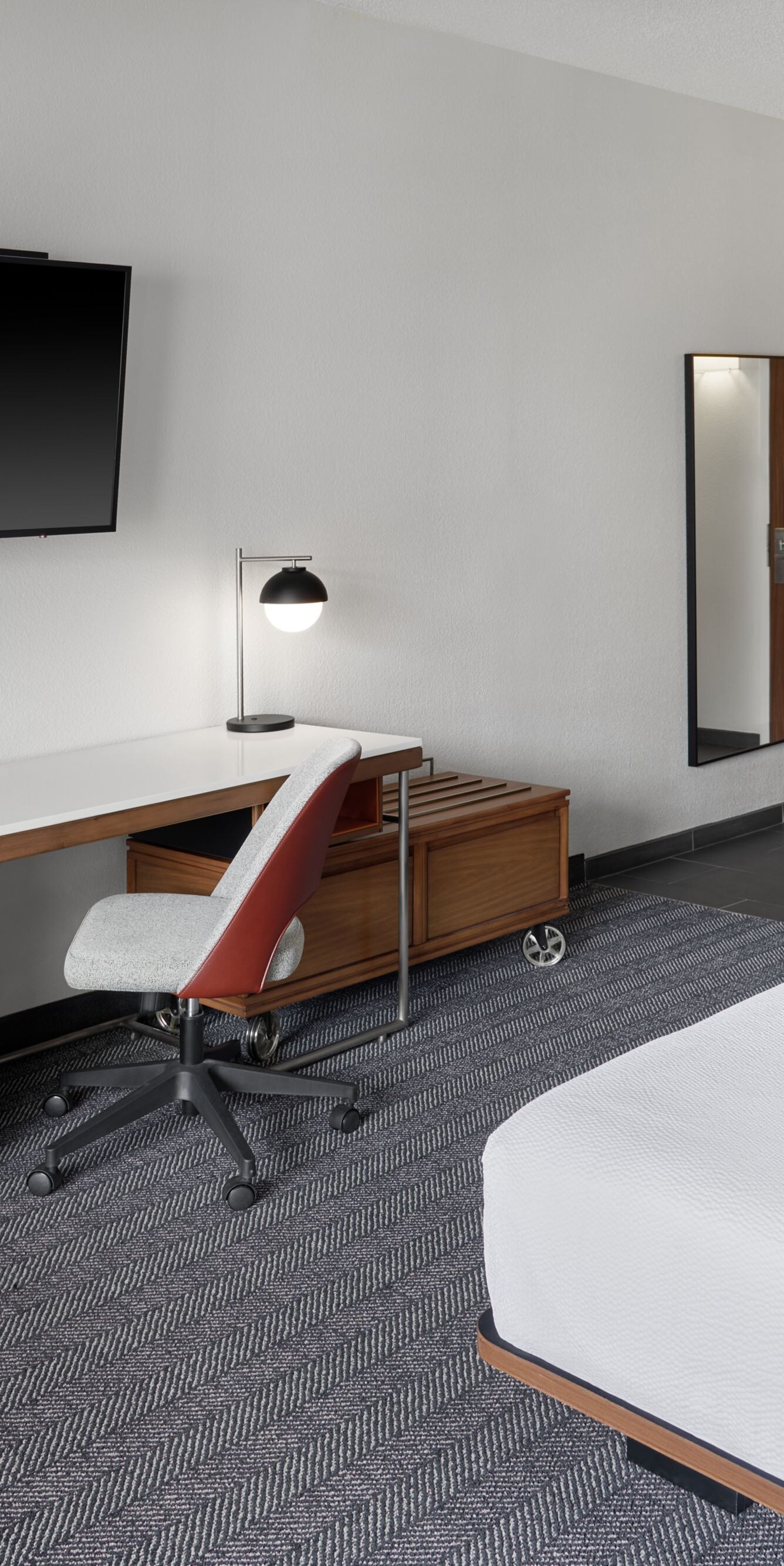 King room with desk, chair, and wall‑mounted TV